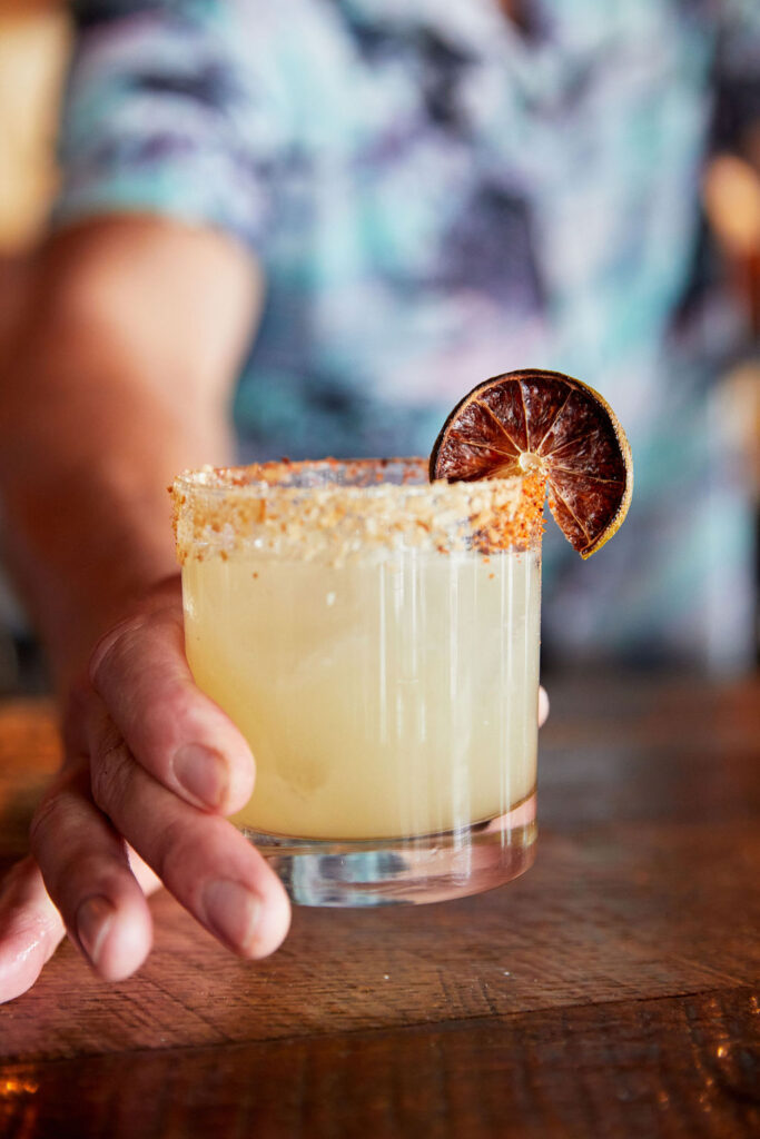 Bartender serving our Gringo Lingo cocktail